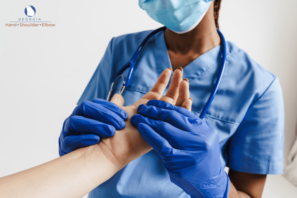 A doctor examining a patient’s hand to determine if surgery would be the best treatment to restore hand function in Georgia,