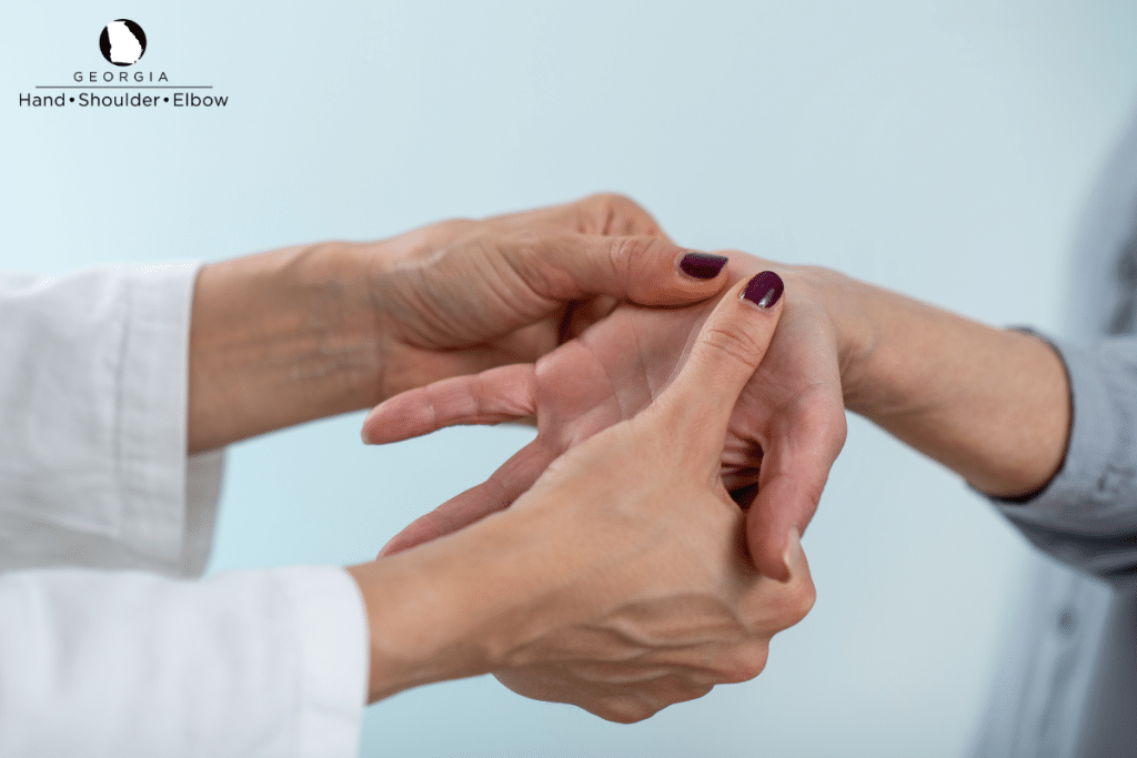 A specialist examining the hand of a patient that is experiencing discomfort and pain in Atlanta, Georgia.